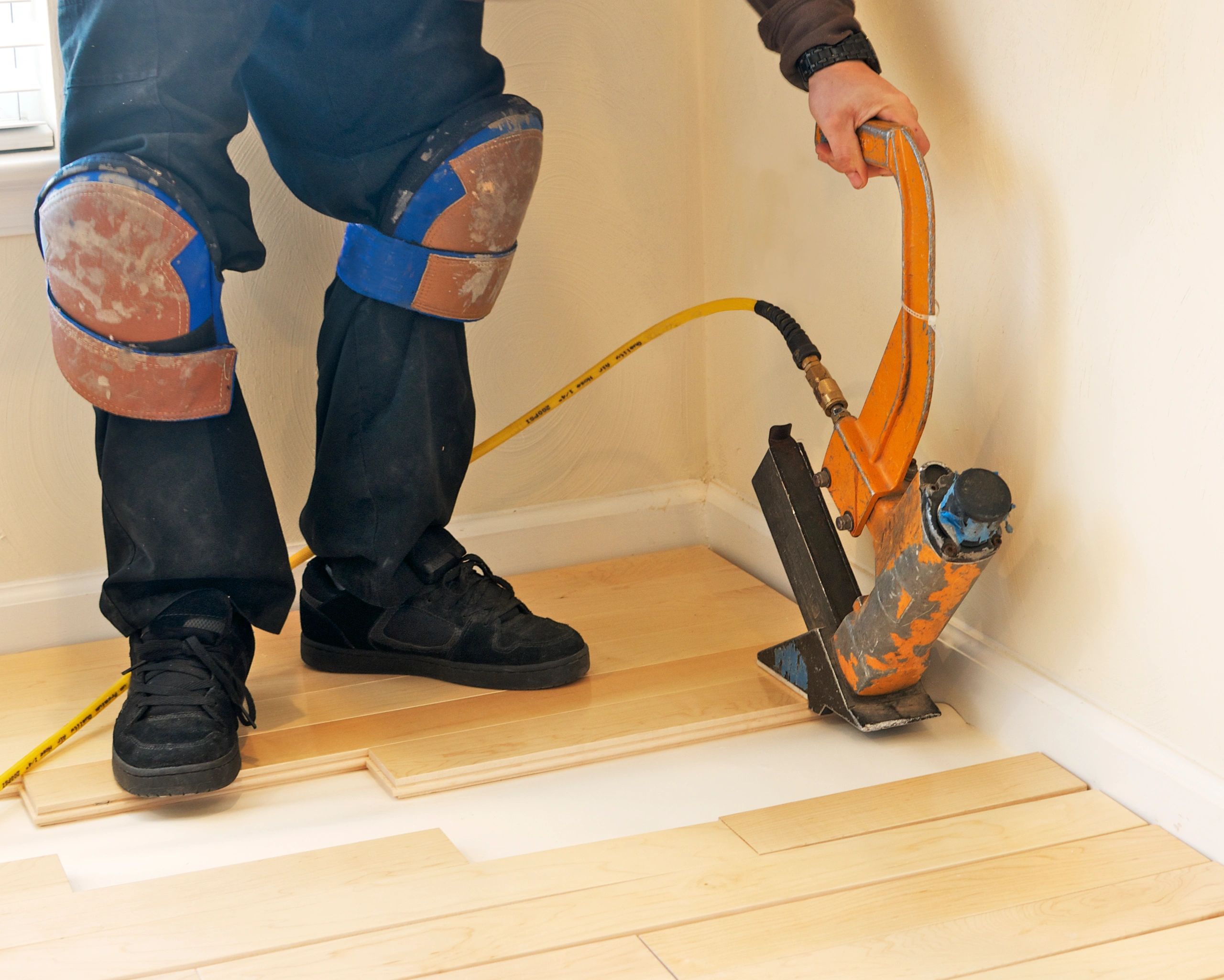 Installer working on hardwood flooring