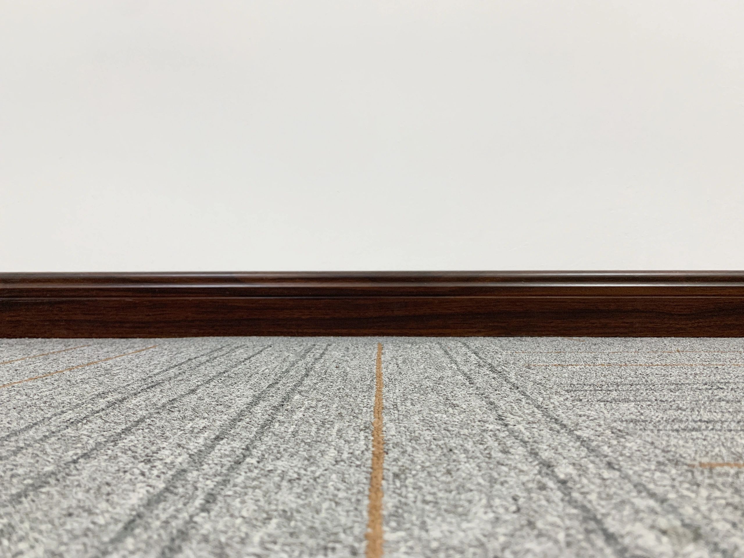 Interior detail showing clean baseboard and finished flooring