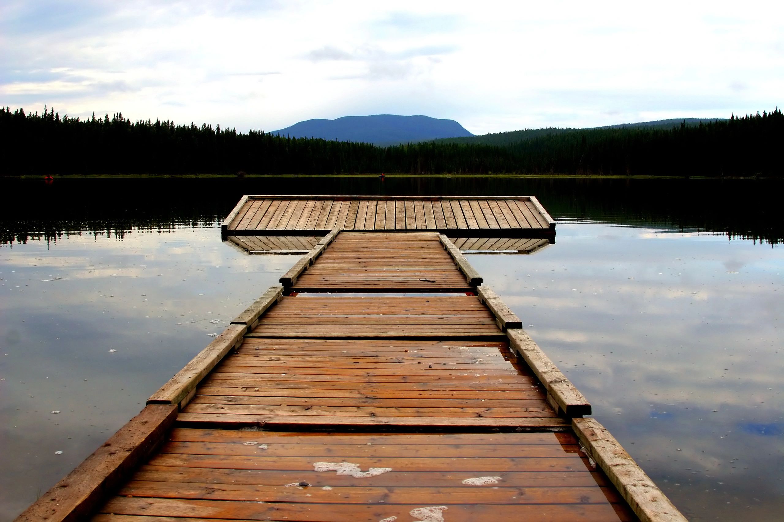 Wooden dock extending onto a calm lake
