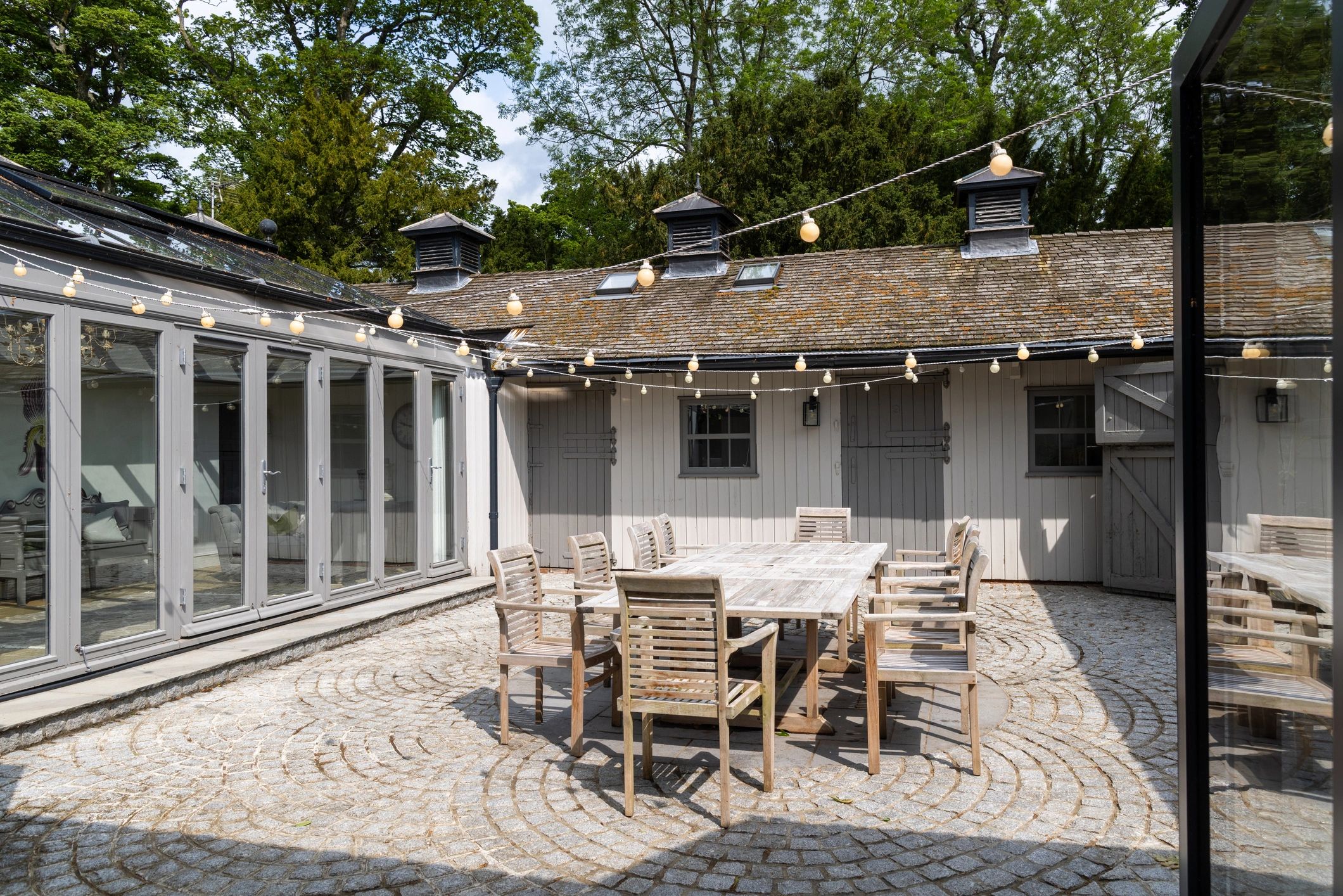 Outdoor courtyard seating area on stone-like pavers