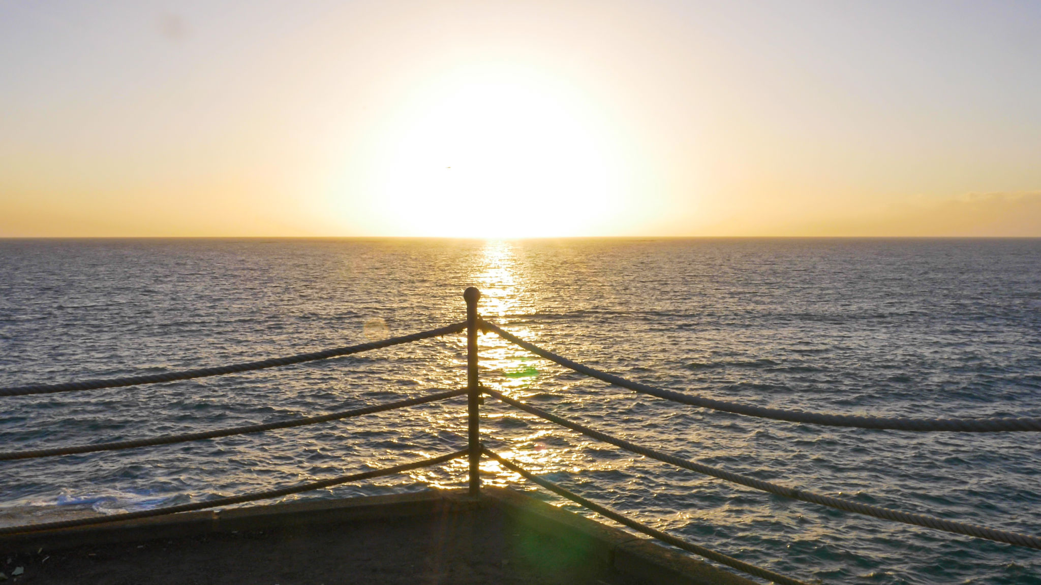 Sunset over water horizon